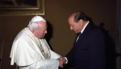 St. Pope John Paul II greets former Italian Prime Minister Silvio Berlusconi.