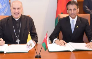 Archbishop Gabriele Caccia, Holy See Permanent Observer to the United Nations (left), and Mohammed Al-Hassan, Ambassador Extraordinary and Plenipotentiary of the Sultanate of Oman to the United Nations, at a signing ceremony establishing diplomatic relations between Oman and the Holy See. The ceremony took place  at the Permanent Mission of the Sultanate of Oman to the United Nations in New York City. Courtesy of Holy See Mission to the United Nations